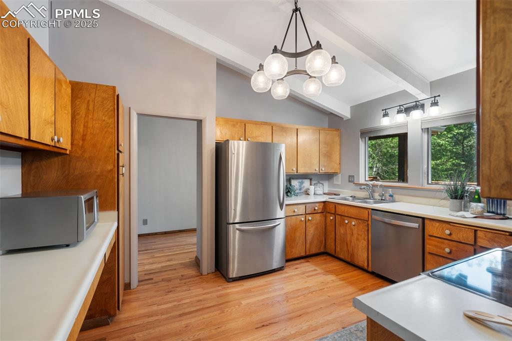 10 Haney Road Colorado Springs, CO 80906 - Photo 21 of 48 a kitchen with stainless steel appliances granite countertop a refrigerator a sink dishwasher a stove and white countertops with wooden floor