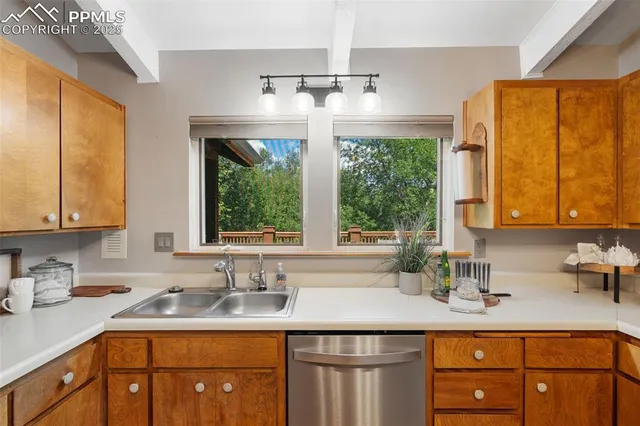 a kitchen with a window a sink and cabinets