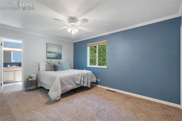a spacious bedroom with a bed and a chandelier