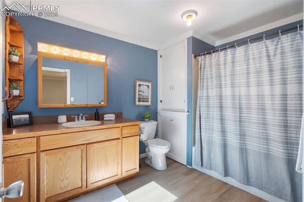 10 Haney Road Colorado Springs, CO 80906 - Photo 26 of 48 a bathroom with a sink a toilet and mirror