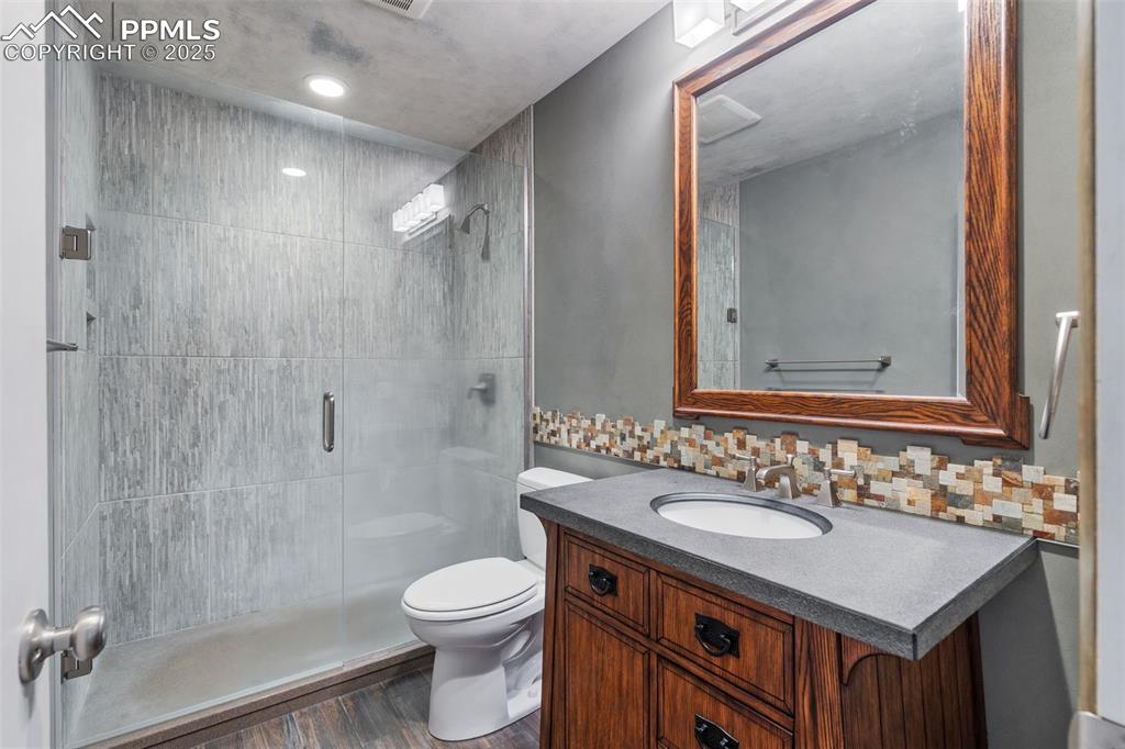 10 Haney Road Colorado Springs, CO 80906 - Photo 28 of 48 a bathroom with a sink toilet a mirror and shower