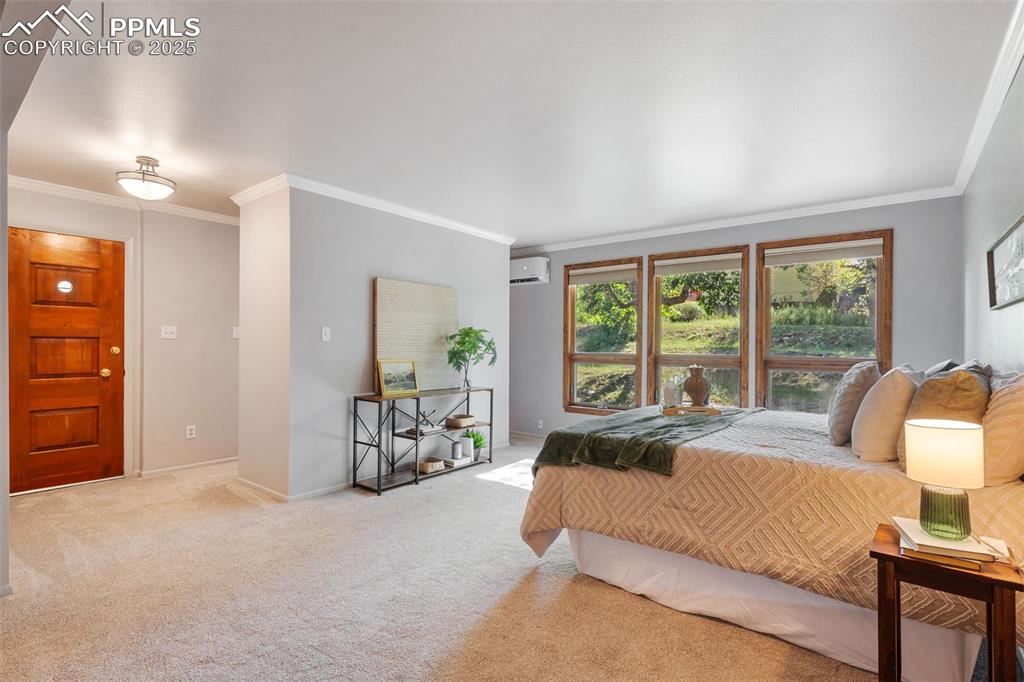 10 Haney Road Colorado Springs, CO 80906 - Photo 32 of 48 a spacious bedroom with a bed and a couch