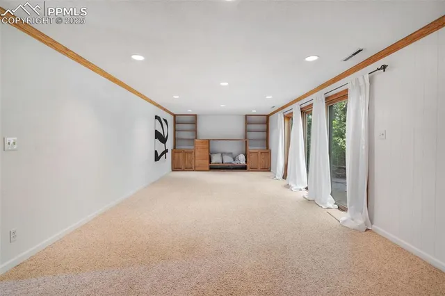 a big room with closet and a large window