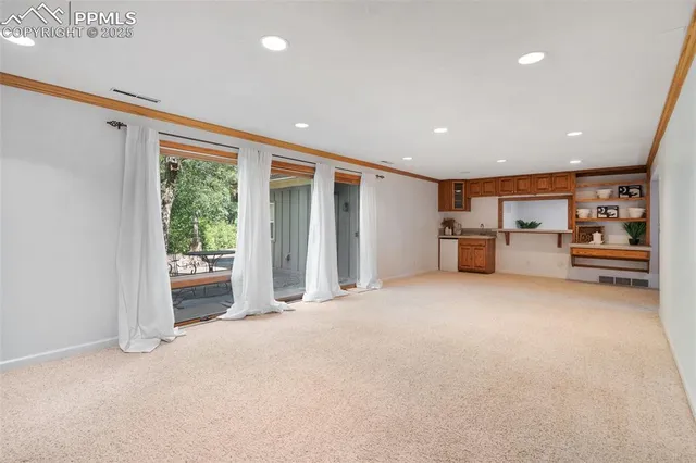 a view of empty room with furniture and storage