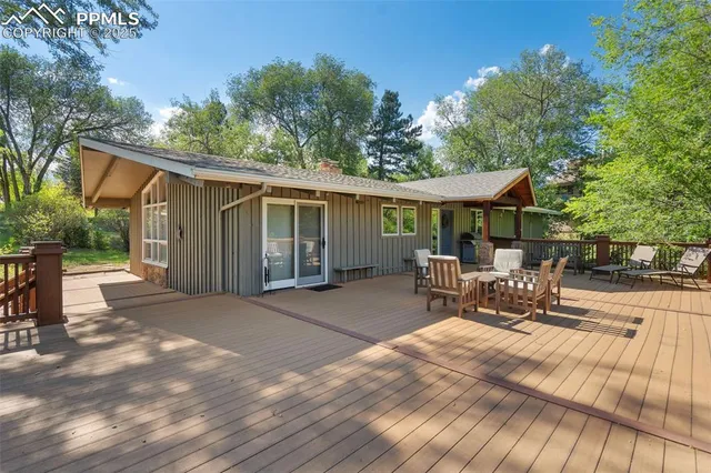 a view of a house with backyard and sitting area