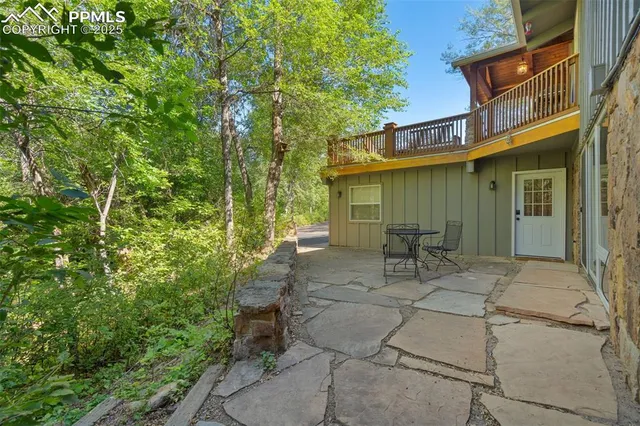 a view of backyard with outdoor seating and green space