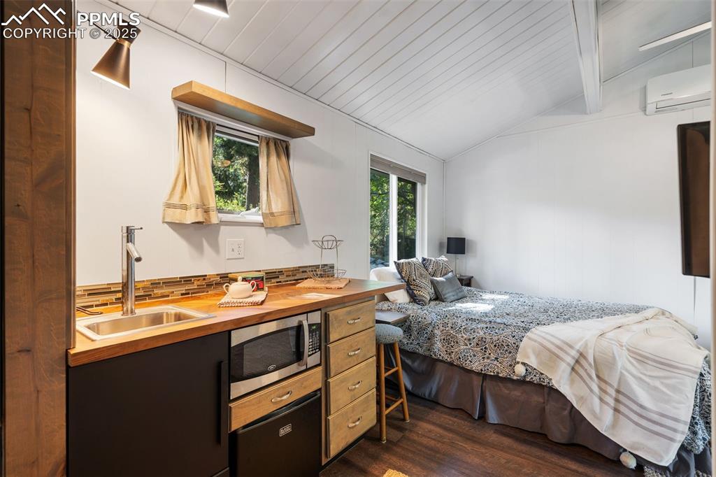 10 Haney Road Colorado Springs, CO 80906 - Photo 43 of 48 a bedroom with a bed and wooden floor