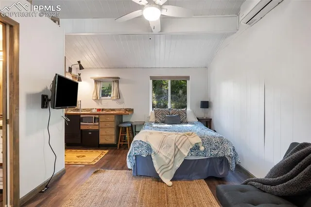 a bedroom with a bed and a television