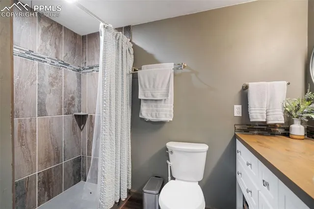 a bathroom with a toilet sink and shower