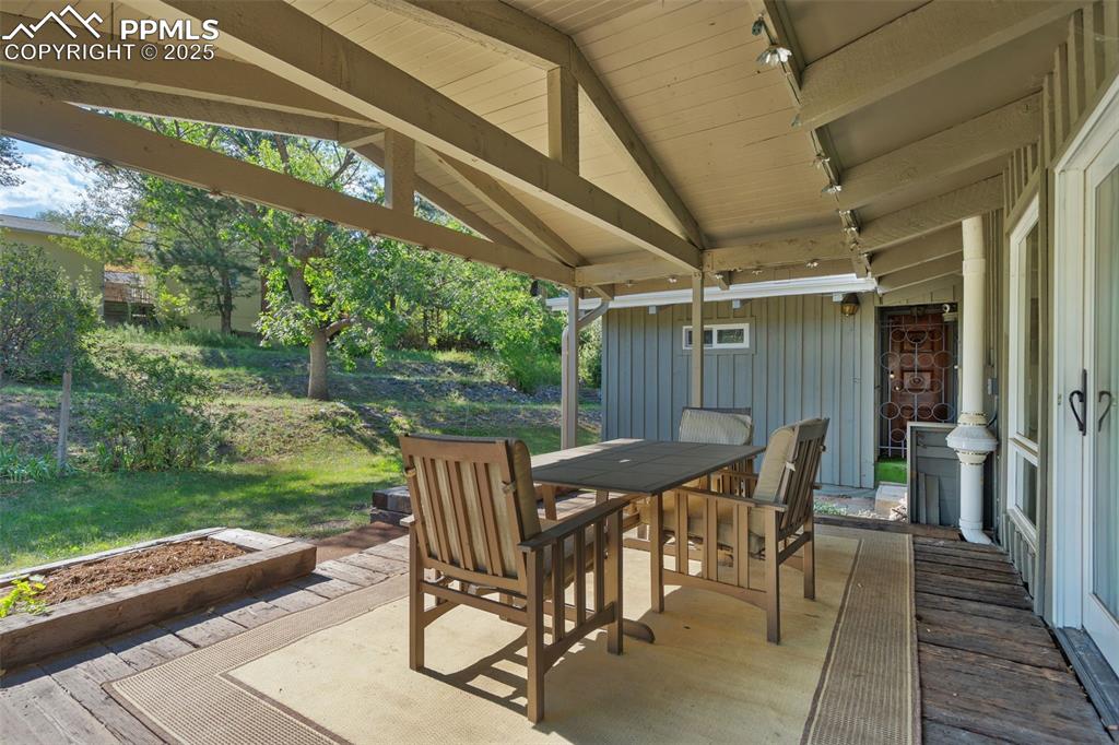 10 Haney Road Colorado Springs, CO 80906 - Photo 48 of 48 a view of a patio with table and chairs with wooden floor and fence