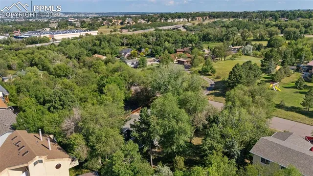 an aerial view of a house with a yard