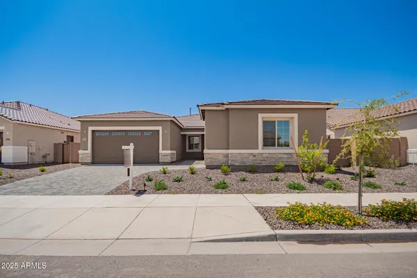 a front view of a house with a yard and garage