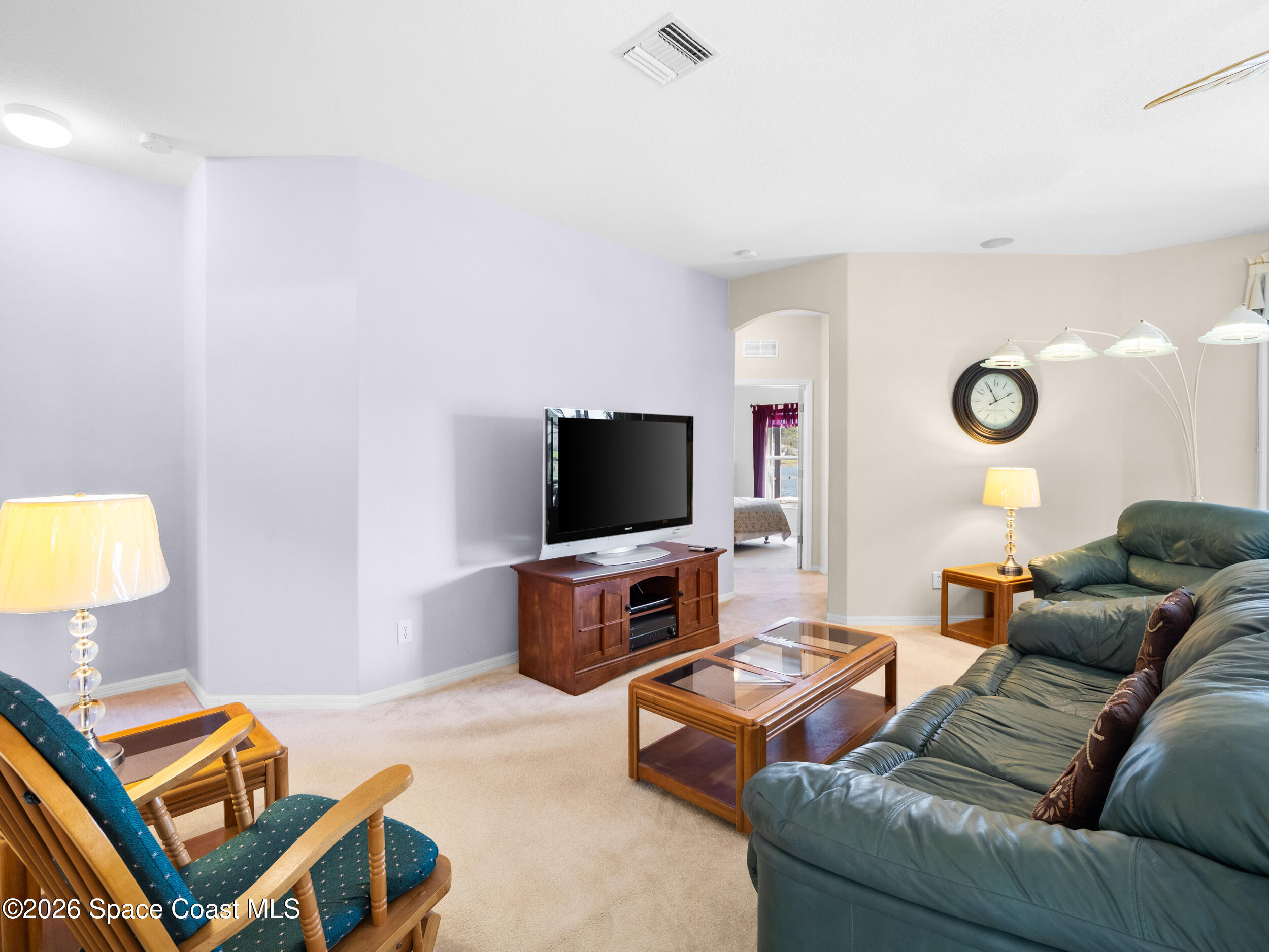 7429 Hackberry Road Cocoa, FL 32927 - Photo 13 of 51 a living room with furniture and a flat screen tv