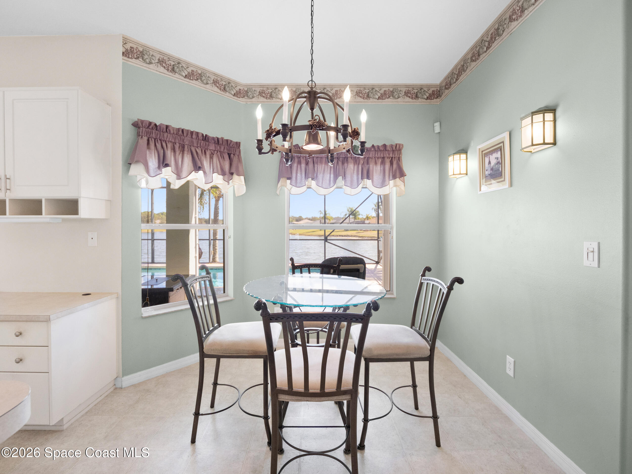 7429 Hackberry Road Cocoa, FL 32927 - Photo 16 of 51 a view of a dining room with furniture a chandelier and wooden floor