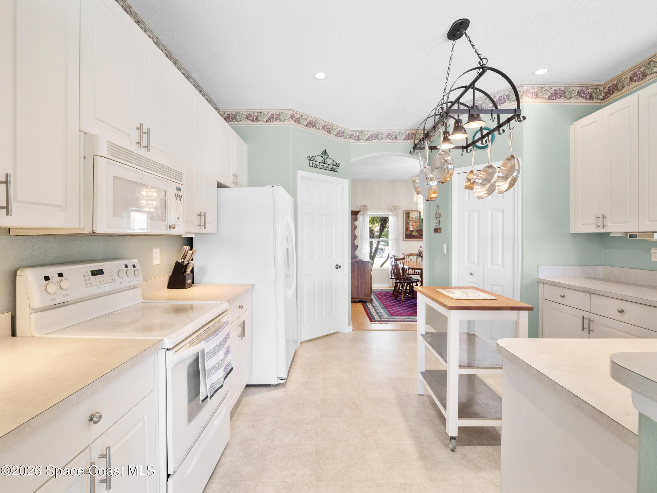 7429 Hackberry Road Cocoa, FL 32927 - Photo 17 of 51 a kitchen that has a lot of cabinets in it and appliances