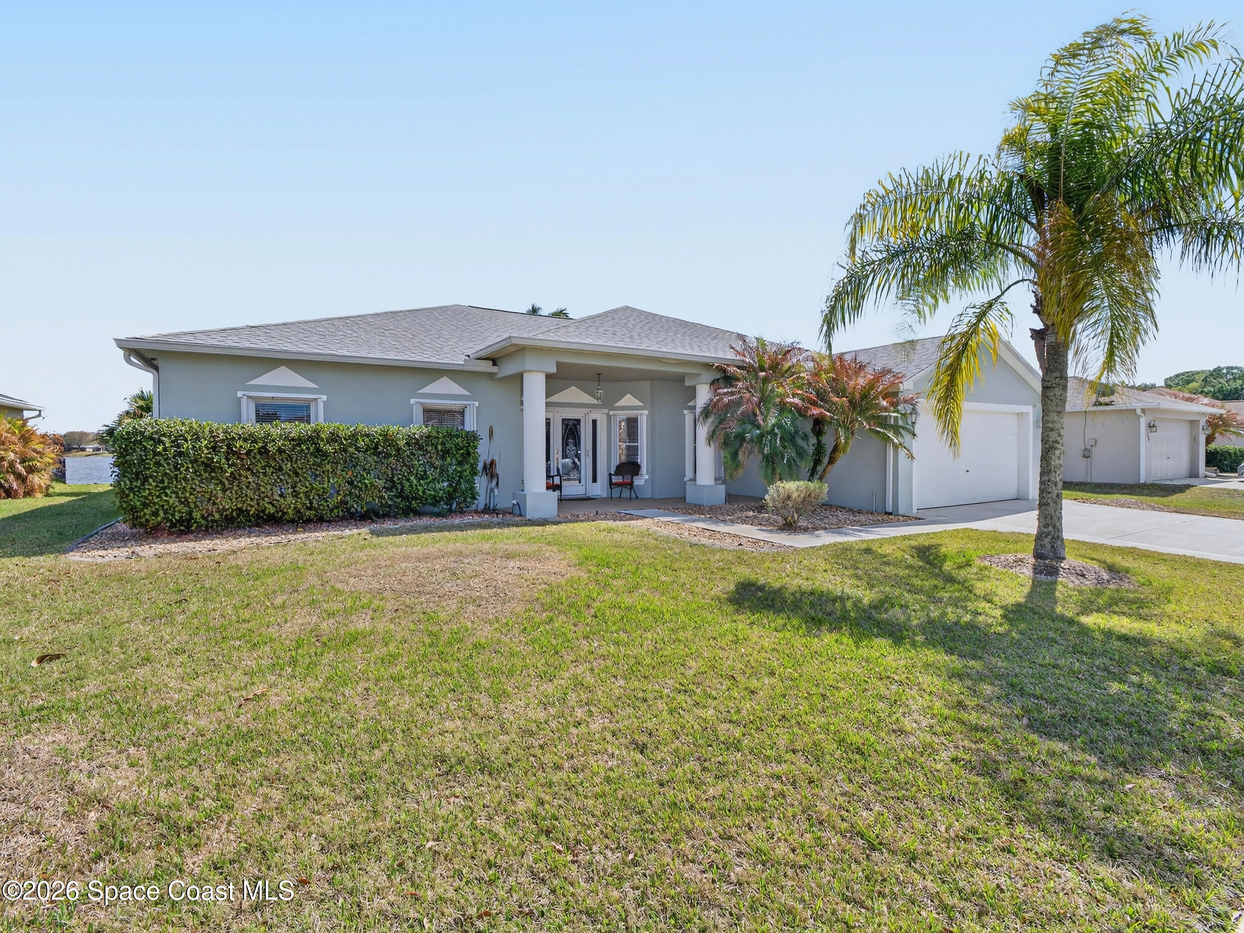 7429 Hackberry Road Cocoa, FL 32927 - Photo 2 of 51 a front view of a house with a yard