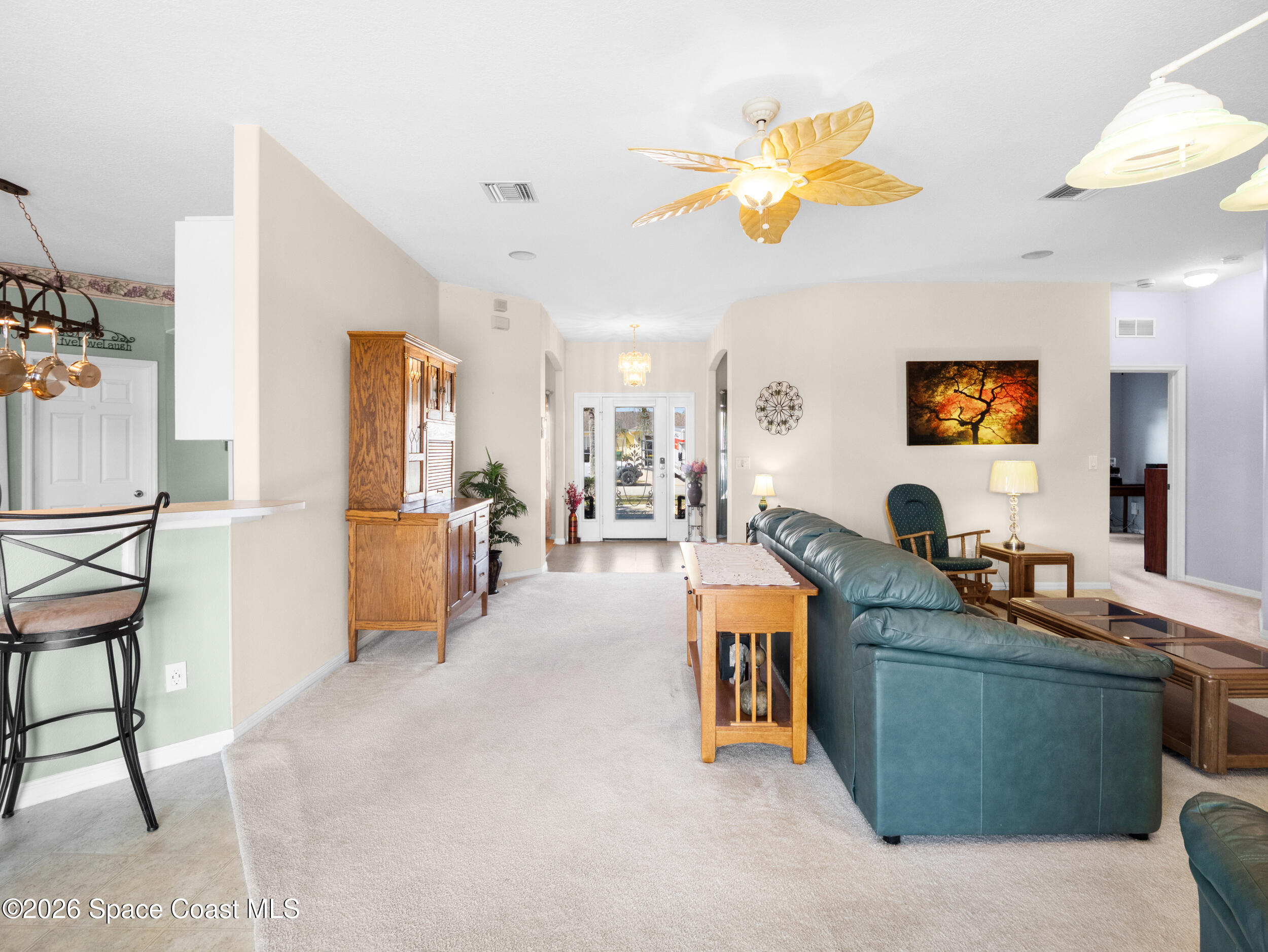 7429 Hackberry Road Cocoa, FL 32927 - Photo 21 of 51 a living room with furniture a dining table and kitchen view