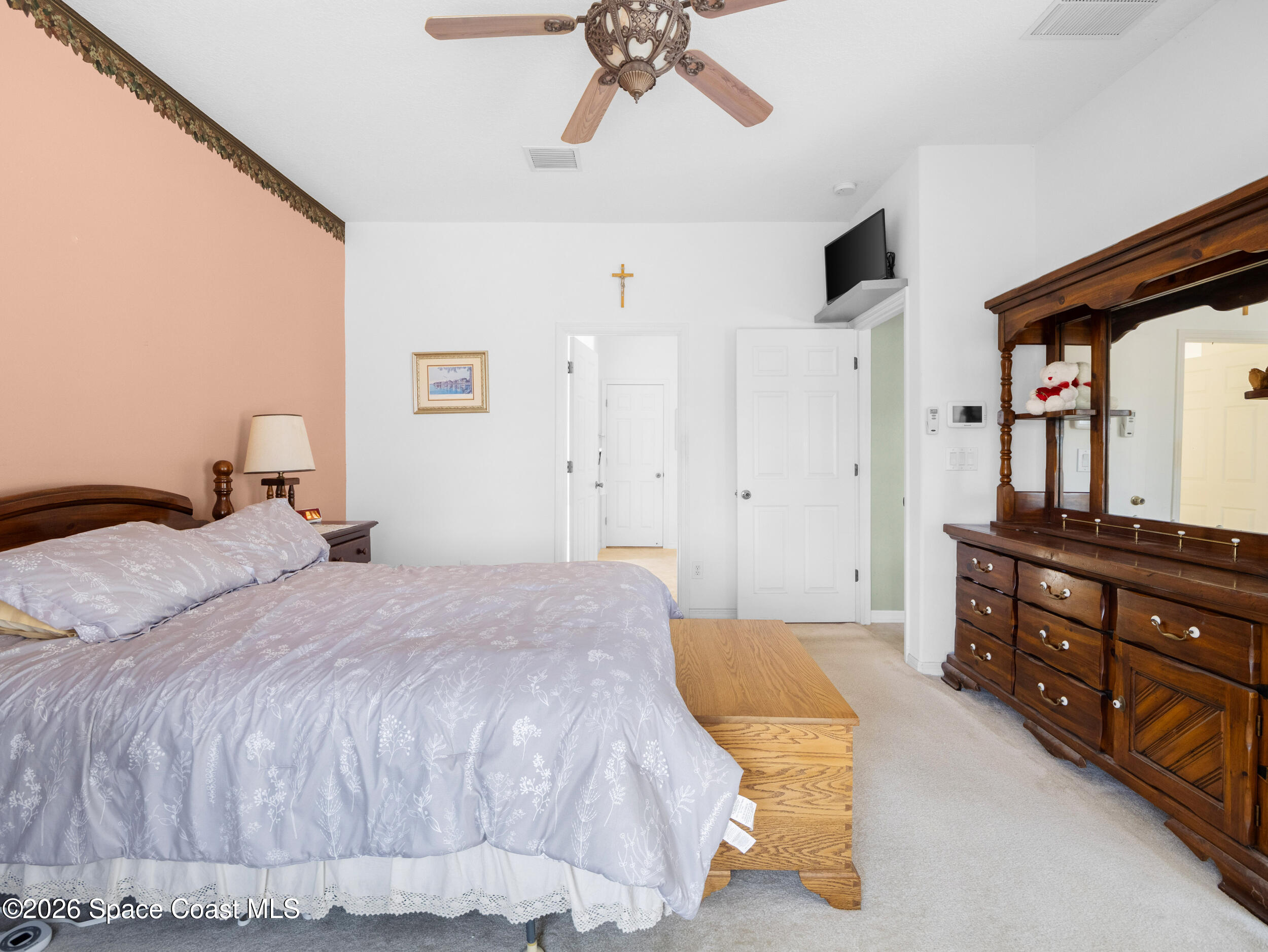 7429 Hackberry Road Cocoa, FL 32927 - Photo 24 of 51 a bedroom with a bed and a dresser