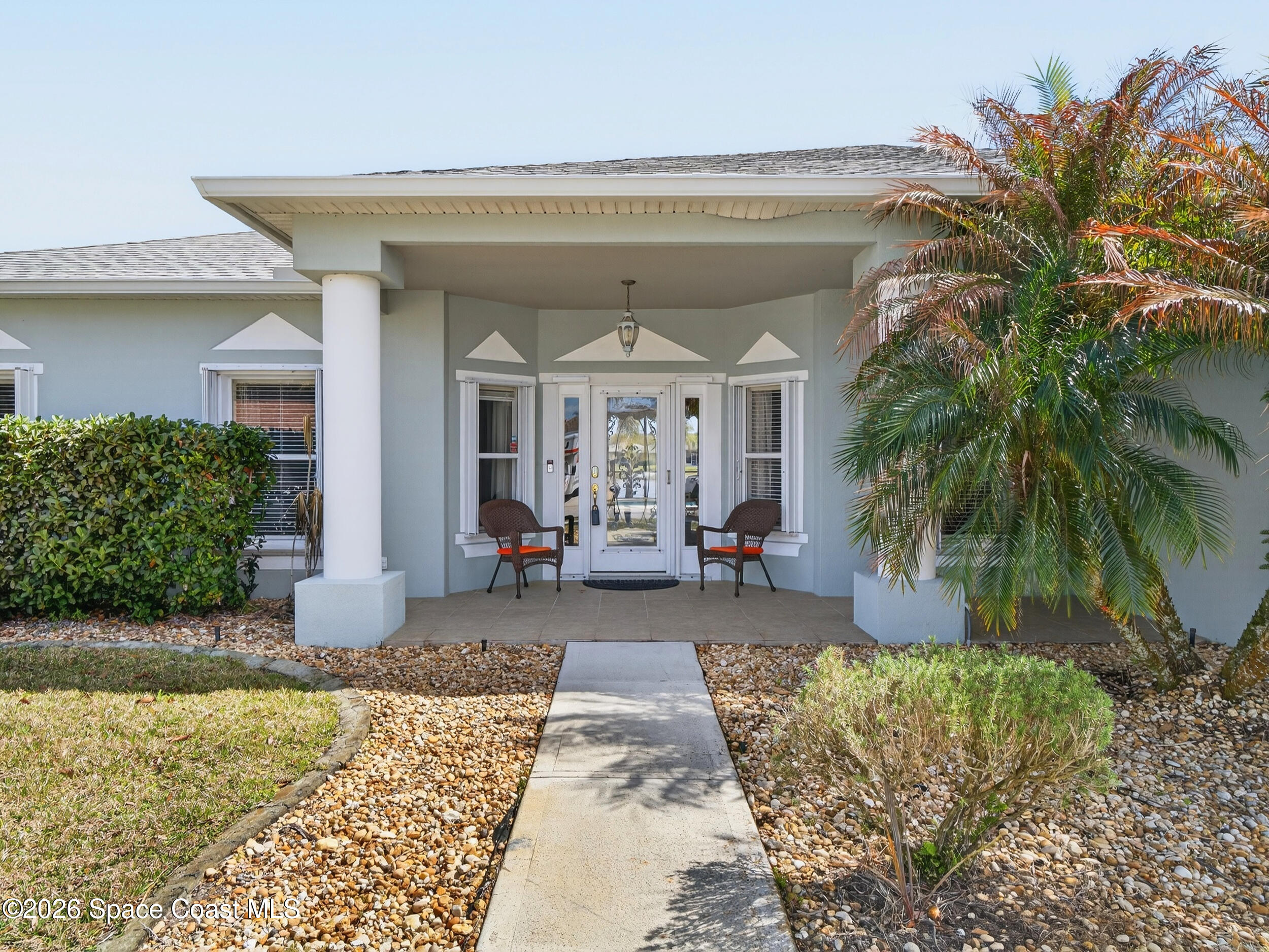 7429 Hackberry Road Cocoa, FL 32927 - Photo 3 of 51 a front view of a house with garden