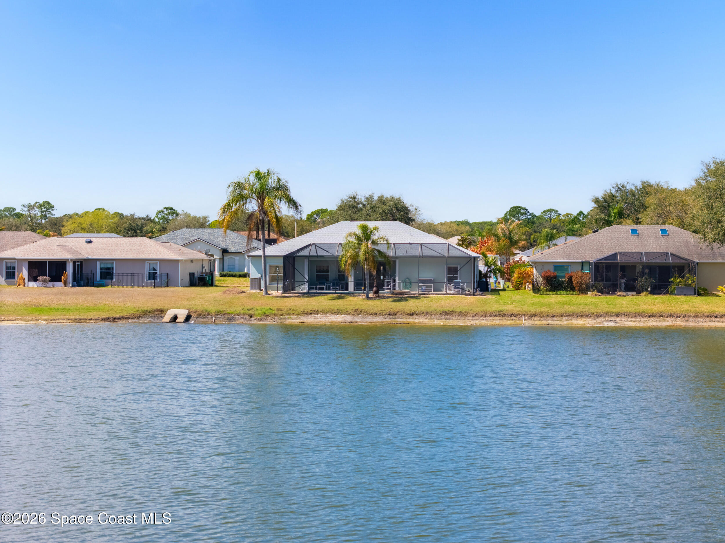 7429 Hackberry Road Cocoa, FL 32927 - Photo 47 of 51 a swimming pool is sitting in the middle of a lake