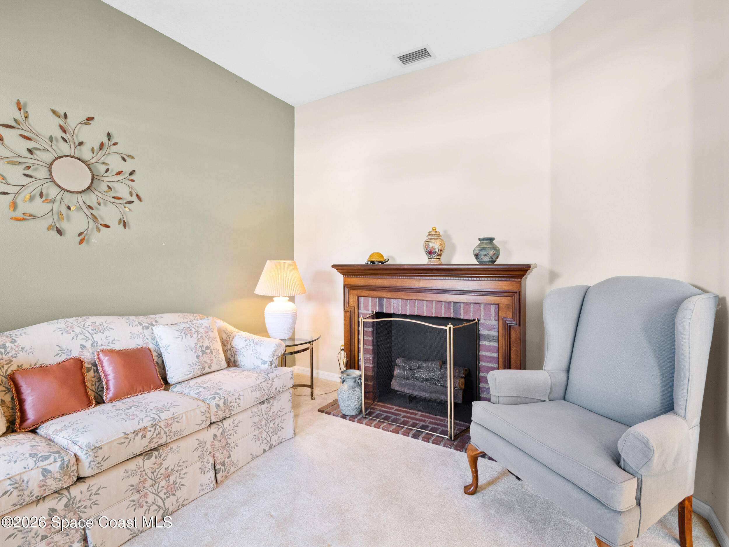7429 Hackberry Road Cocoa, FL 32927 - Photo 6 of 51 a living room with furniture and a fireplace