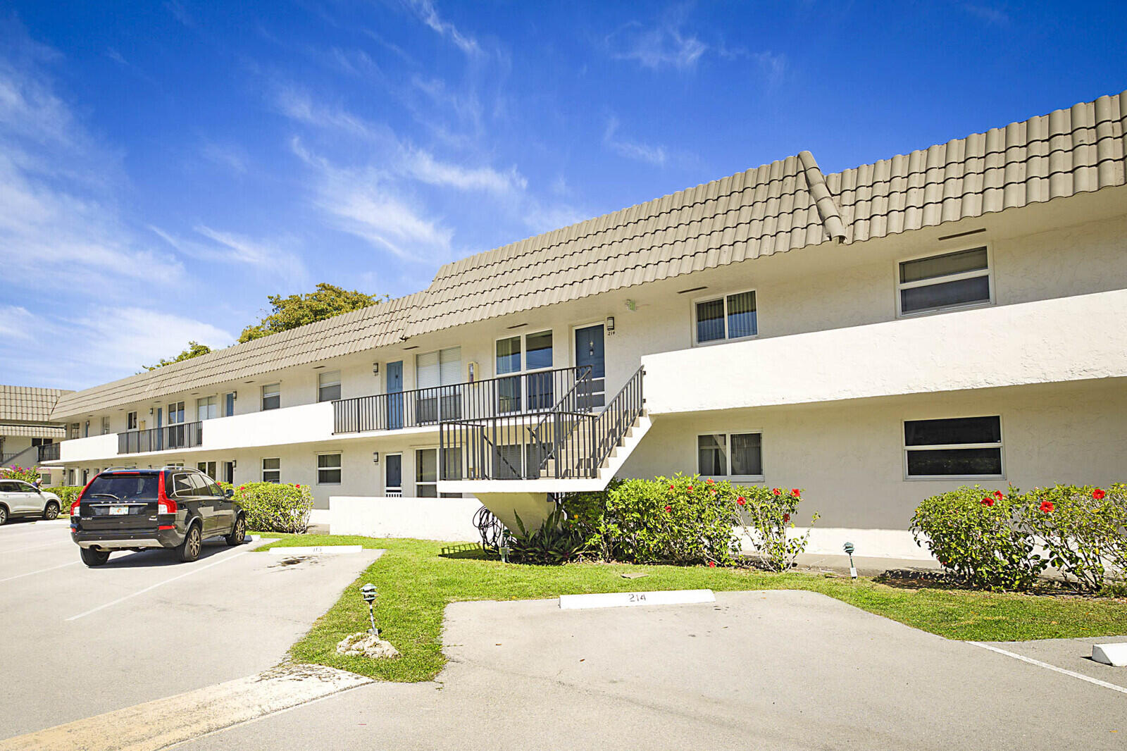 a front view of a house with a garden