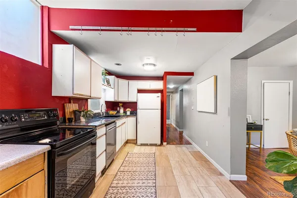 a kitchen with stainless steel appliances granite countertop a stove a sink and a refrigerator