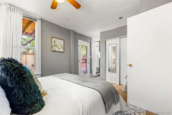 a bedroom with a bed and a window