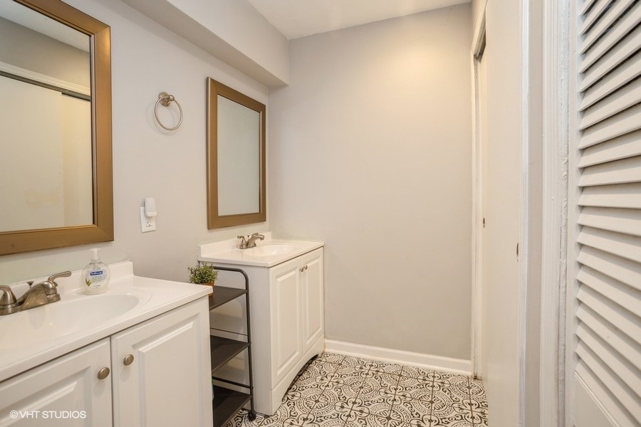 551 Ridge Circle Streamwood, IL 60107 - Photo 11 of 17 a bathroom with a sink and a mirror