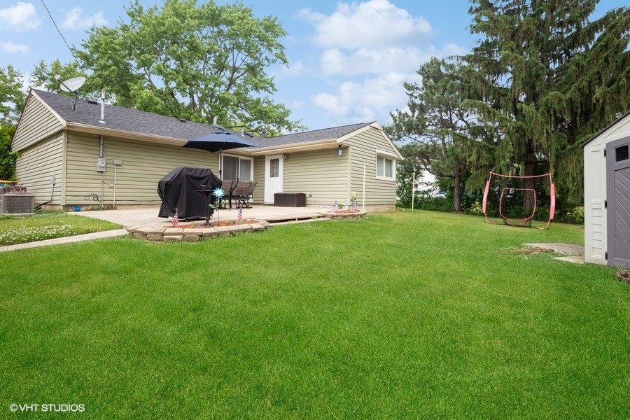 551 Ridge Circle Streamwood, IL 60107 - Photo 15 of 17 a house view with a sitting space and garden