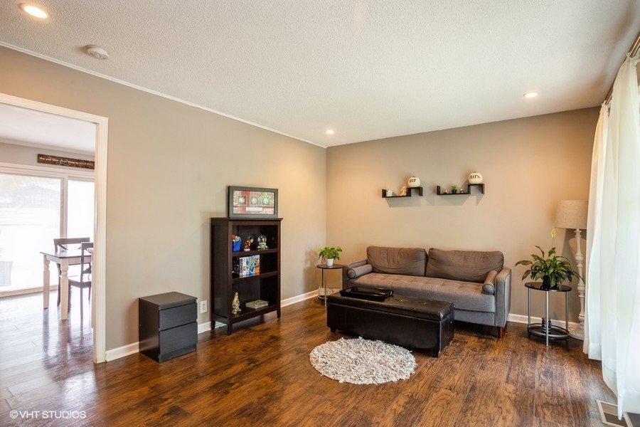 551 Ridge Circle Streamwood, IL 60107 - Photo 2 of 17 a living room with furniture and a wooden floor