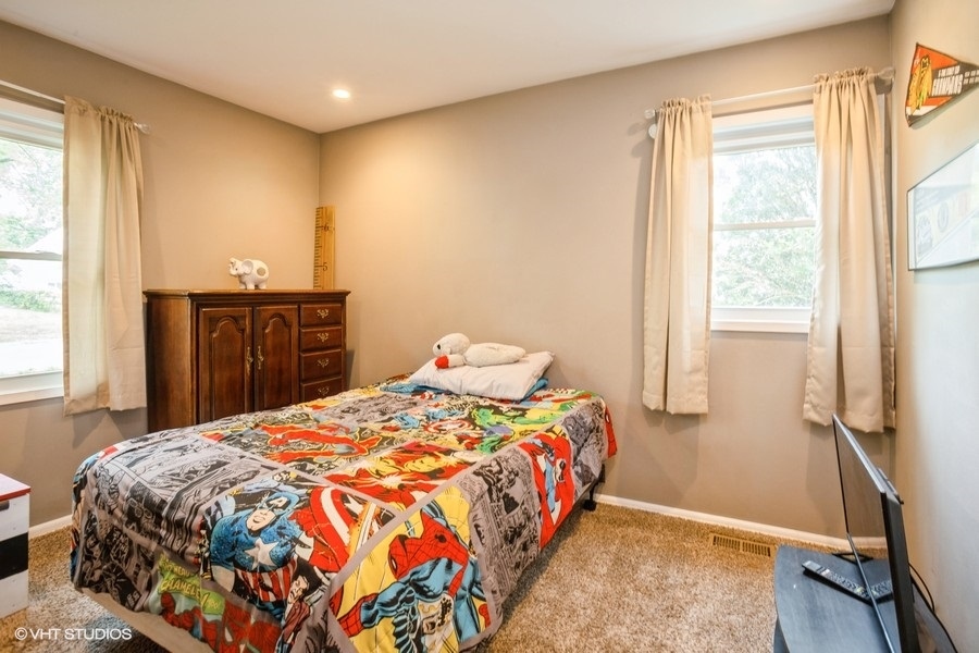 551 Ridge Circle Streamwood, IL 60107 - Photo 8 of 17 a bedroom with a bed and a window