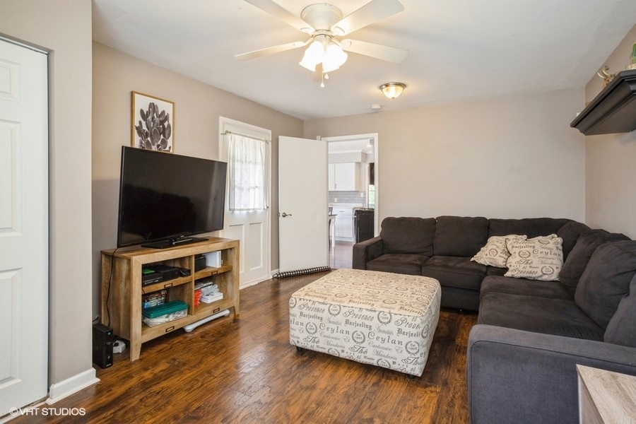 551 Ridge Circle Streamwood, IL 60107 - Photo 10 of 17 a living room with furniture and a flat screen tv