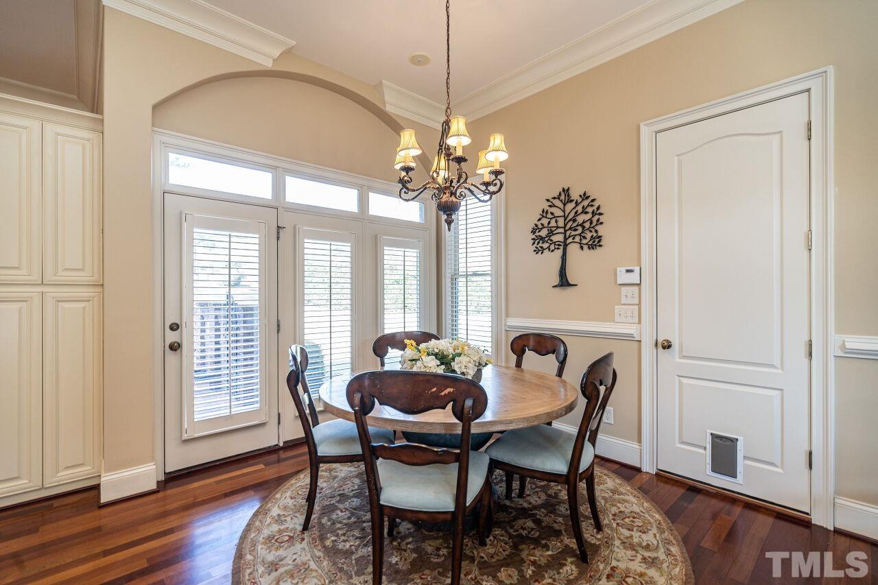 122 Lake Boone Trail Raleigh, NC 27608 - Photo 14 of 46 a dining room with furniture a chandelier and wooden floor
