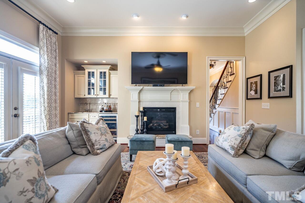 122 Lake Boone Trail Raleigh, NC 27608 - Photo 19 of 46 a living room with furniture a flat screen tv and a fireplace