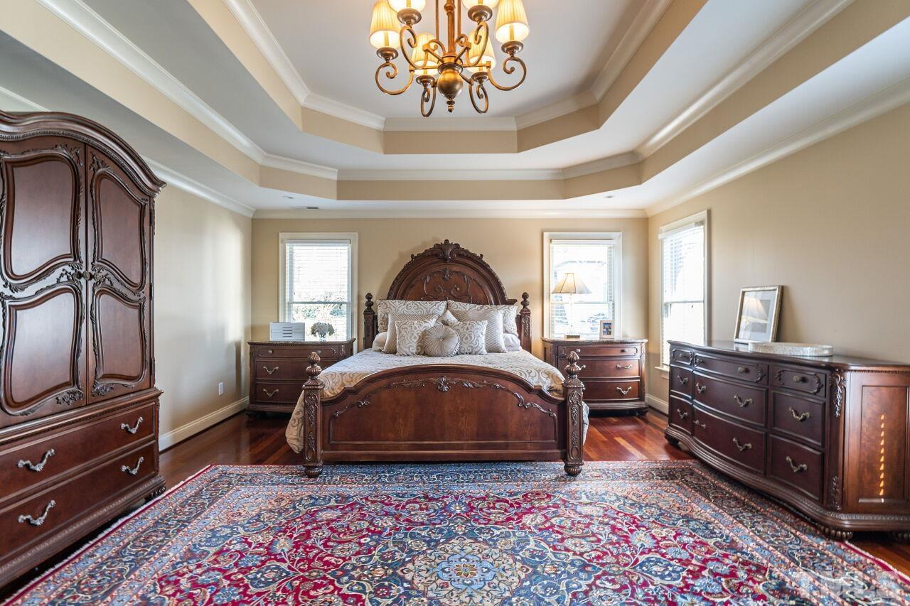 122 Lake Boone Trail Raleigh, NC 27608 - Photo 23 of 46 a bedroom with a bed and wooden floor