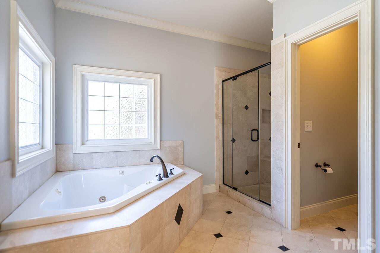 122 Lake Boone Trail Raleigh, NC 27608 - Photo 33 of 46 a bathroom with a tub a sink and a window