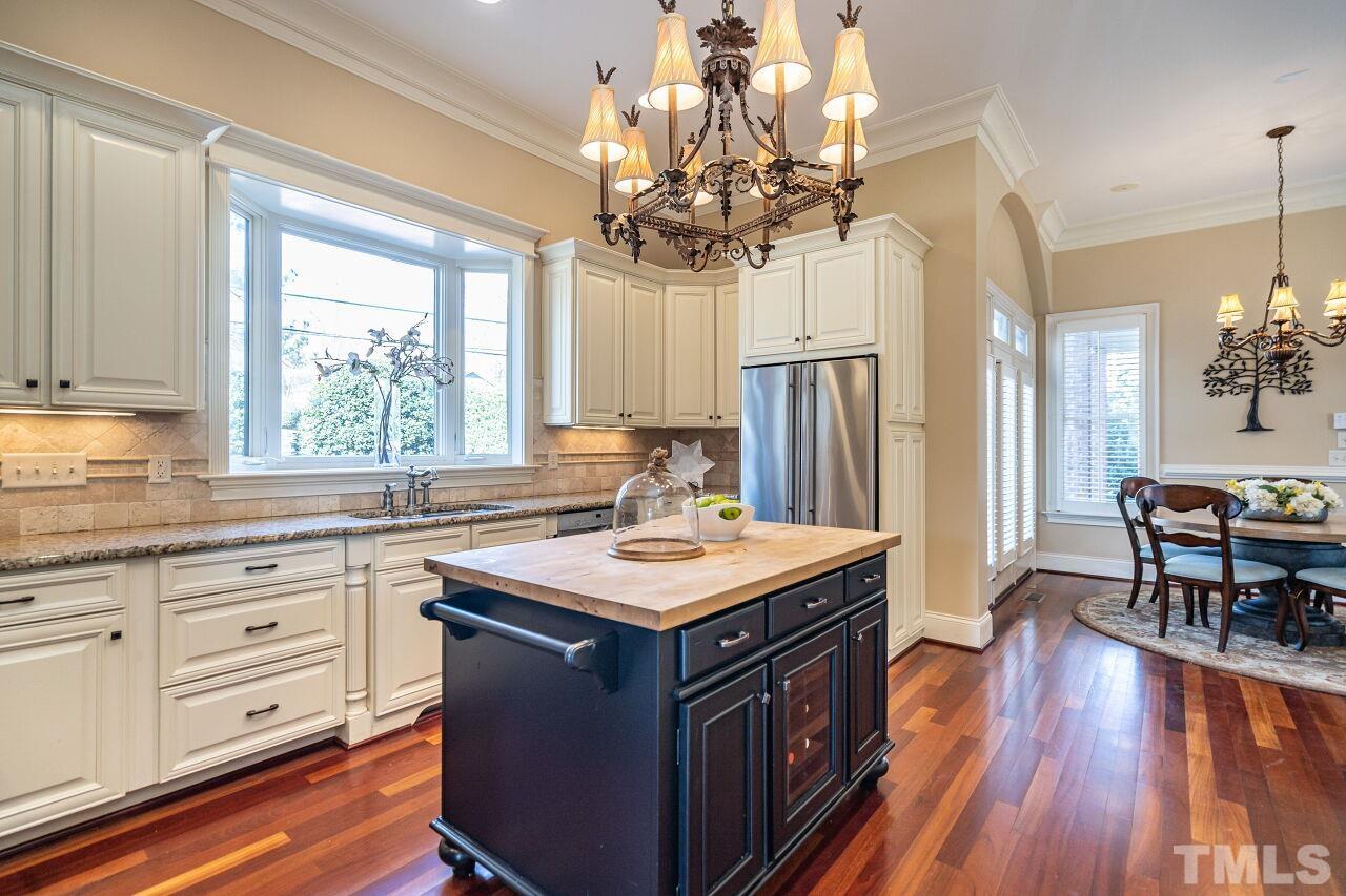 122 Lake Boone Trail Raleigh, NC 27608 - Photo 9 of 46 a kitchen with wooden cabinets and center island