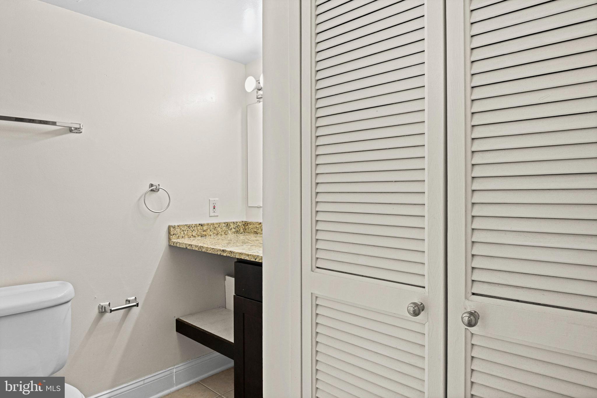1808 Old Meadow Road, Unit 716 McLean, VA 22102 - Photo 16 of 36 a bathroom with a sink a toilet and shower