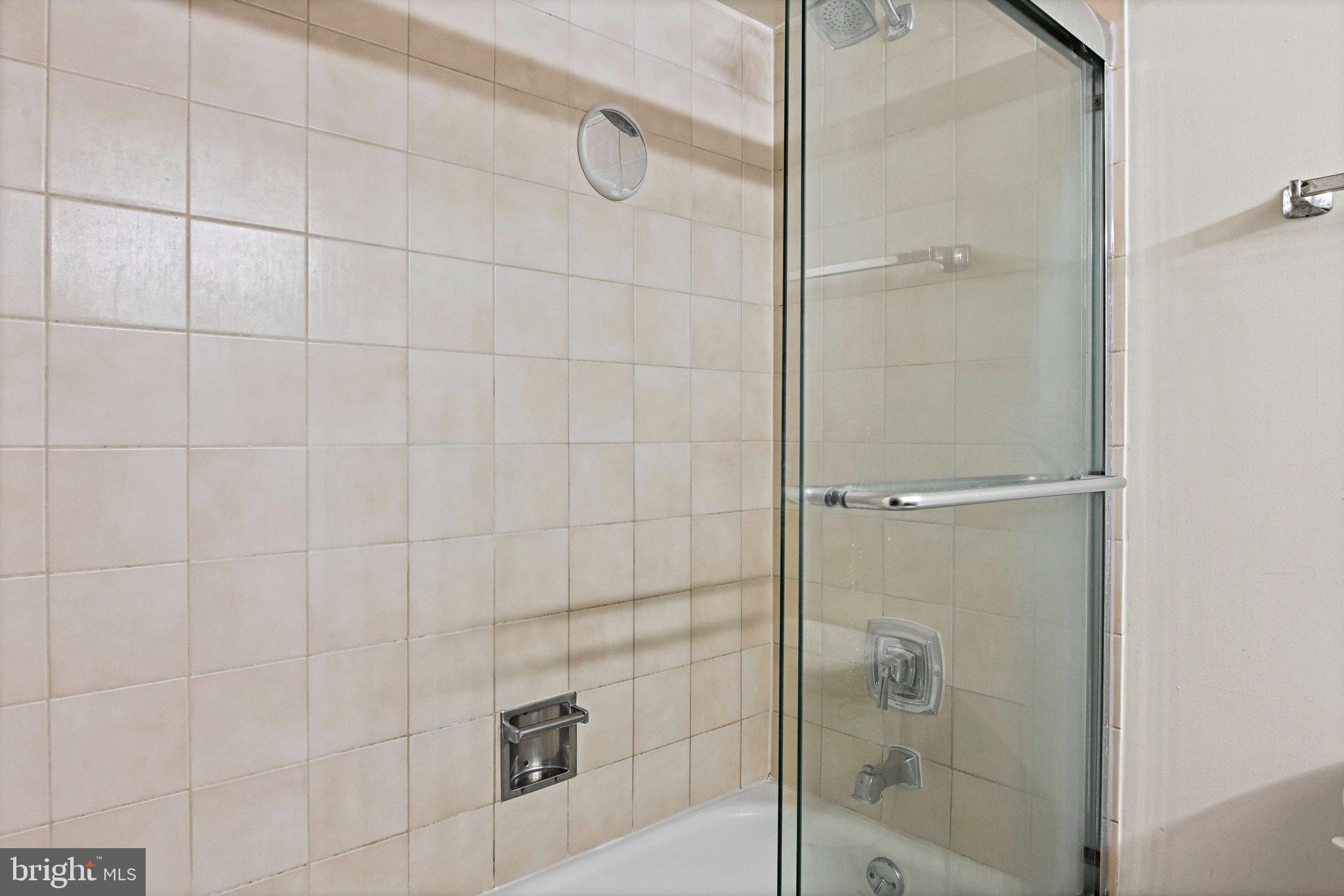 1808 Old Meadow Road, Unit 716 McLean, VA 22102 - Photo 17 of 36 a bathroom with a glass shower door