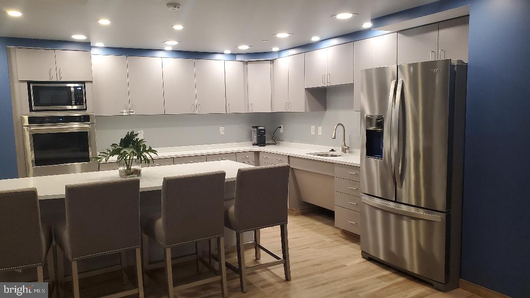 1808 Old Meadow Road, Unit 716 McLean, VA 22102 - Photo 28 of 36 a kitchen with a sink stainless steel appliances and refrigerator