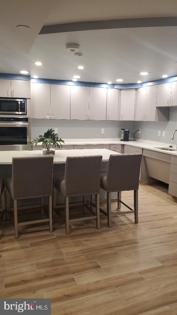 1808 Old Meadow Road, Unit 716 McLean, VA 22102 - Photo 29 of 36 a kitchen with a dining table chairs and wooden floor