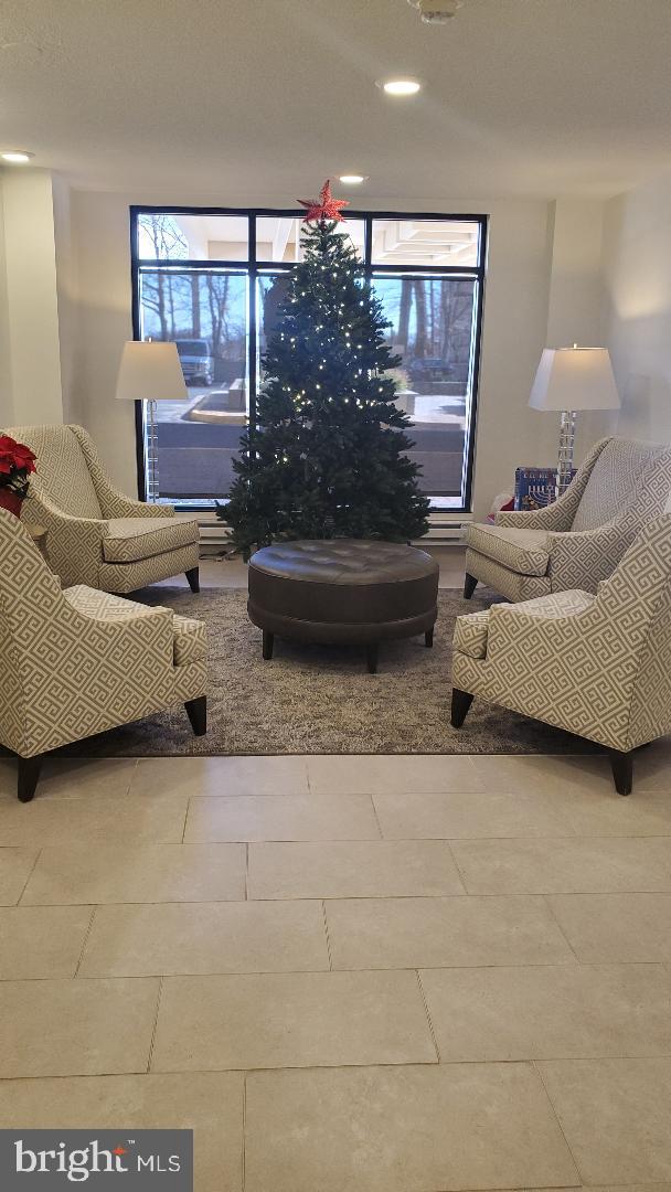 1808 Old Meadow Road, Unit 716 McLean, VA 22102 - Photo 31 of 36 a living room with furniture and a potted plant