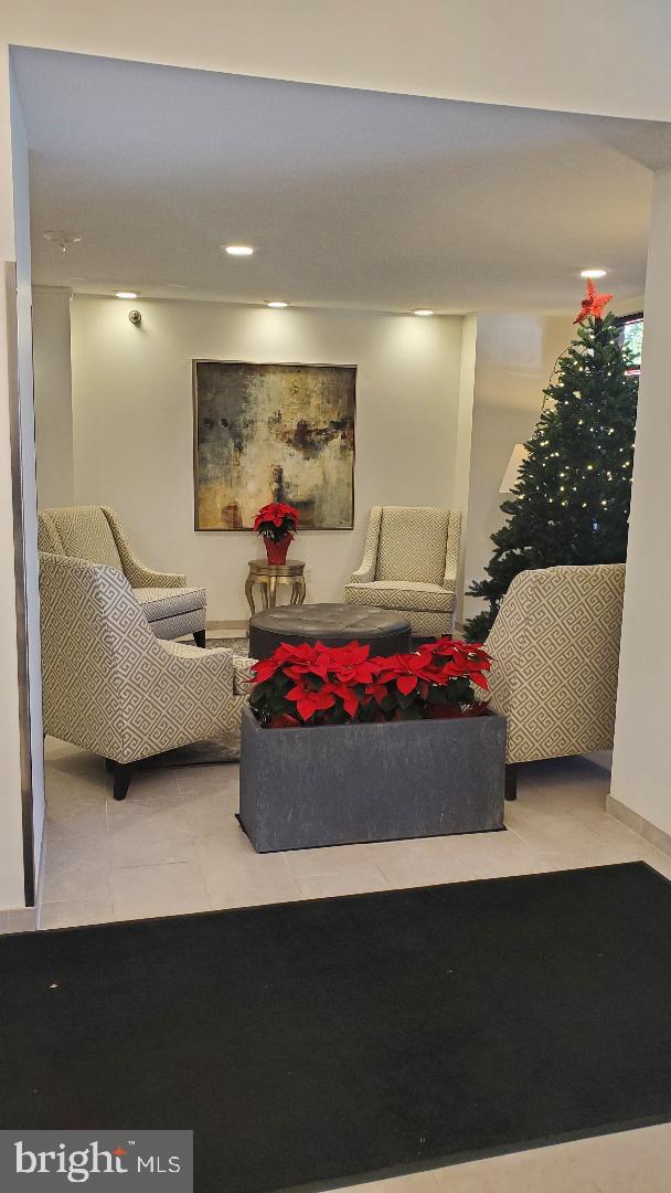 1808 Old Meadow Road, Unit 716 McLean, VA 22102 - Photo 33 of 36 a living room with furniture and a potted plant