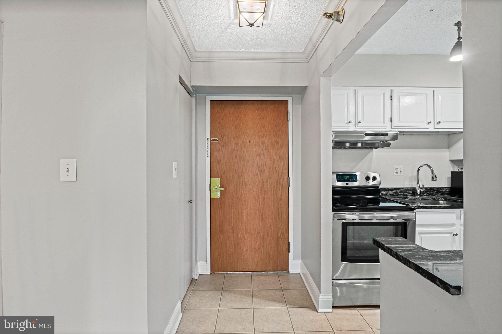 1808 Old Meadow Road, Unit 716 McLean, VA 22102 - Photo 4 of 36 a kitchen with stainless steel appliances granite countertop a stove and a refrigerator