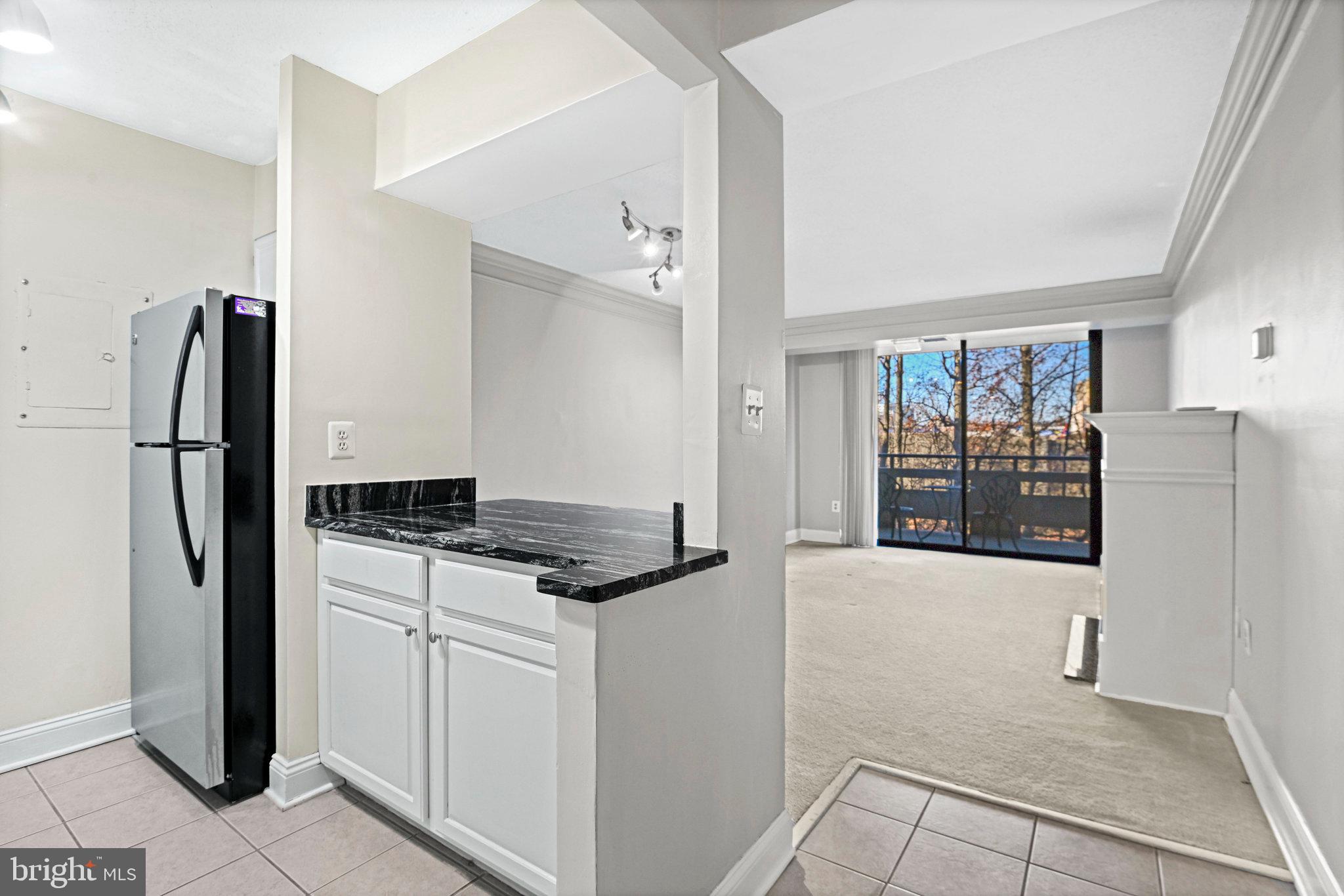 1808 Old Meadow Road, Unit 716 McLean, VA 22102 - Photo 5 of 36 a kitchen with stainless steel appliances granite countertop a refrigerator and a stove