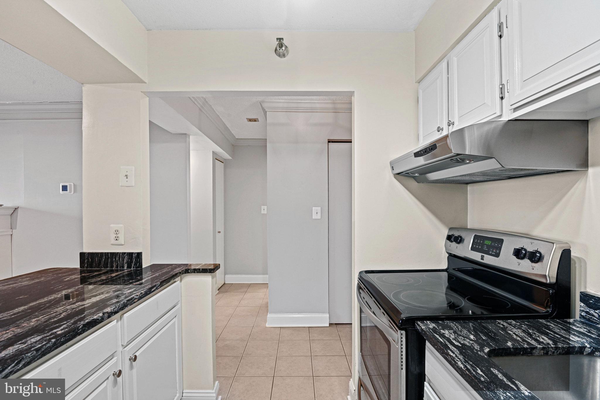 1808 Old Meadow Road, Unit 716 McLean, VA 22102 - Photo 7 of 36 a kitchen with stainless steel appliances granite countertop a stove and a sink