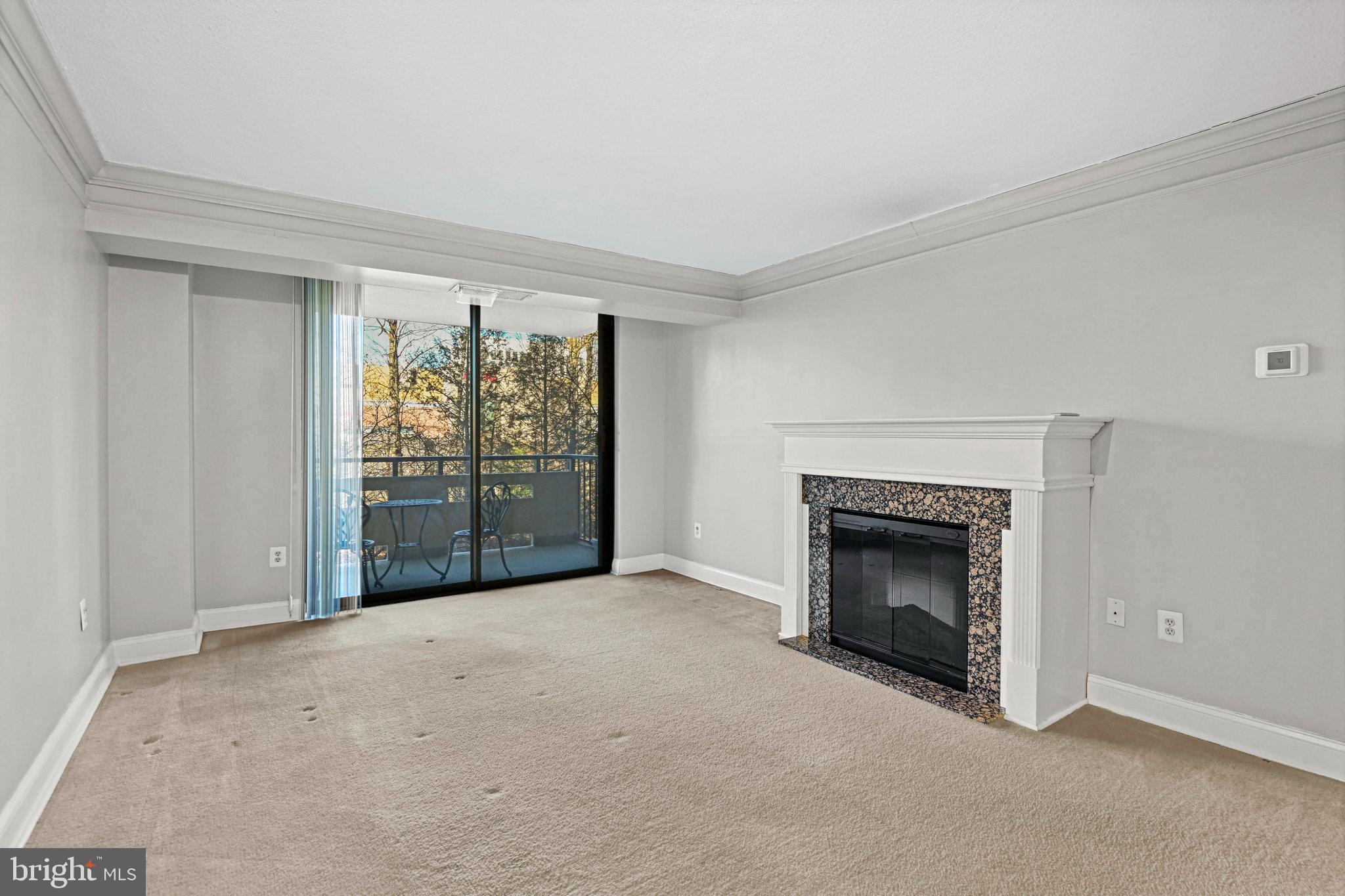 1808 Old Meadow Road, Unit 716 McLean, VA 22102 - Photo 9 of 36 an empty room with furniture and a fireplace