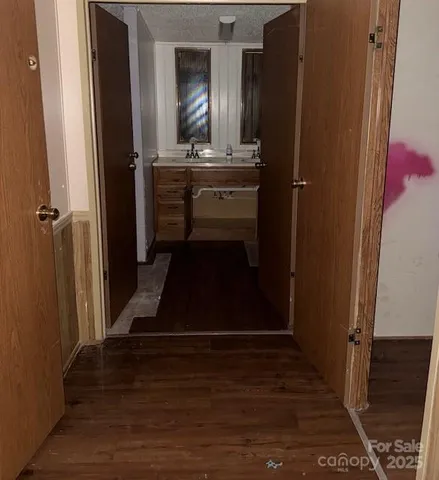 a room with wooden floor and potted plant