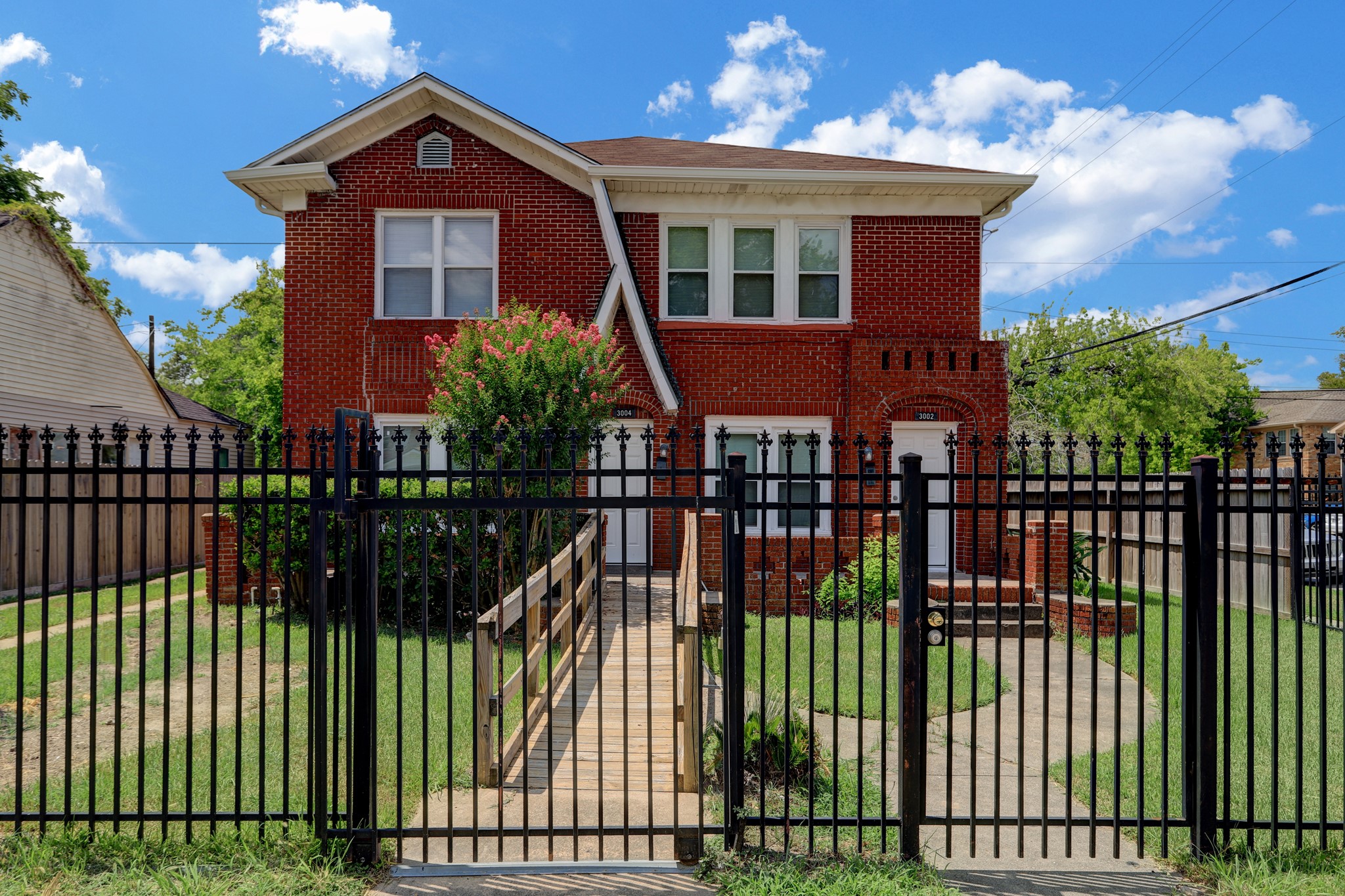3002 Isabella Street Houston, TX 77004 - Photo 1 of 18 a front view of a house with a garden